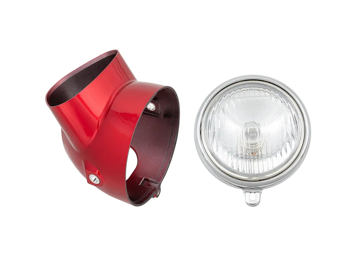 Red metal bike light cover and clear glass light bulb on a white background